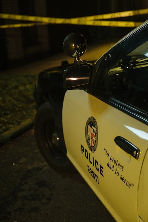 LAPD police car with crime scene tape — failing to report a car accident can result in criminal charges