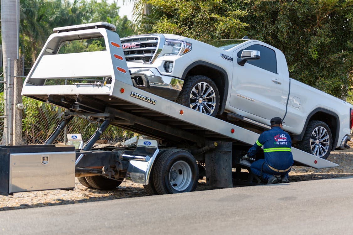 Tow truck loading a vehicle after a car accident — the start of the insurance settlement process