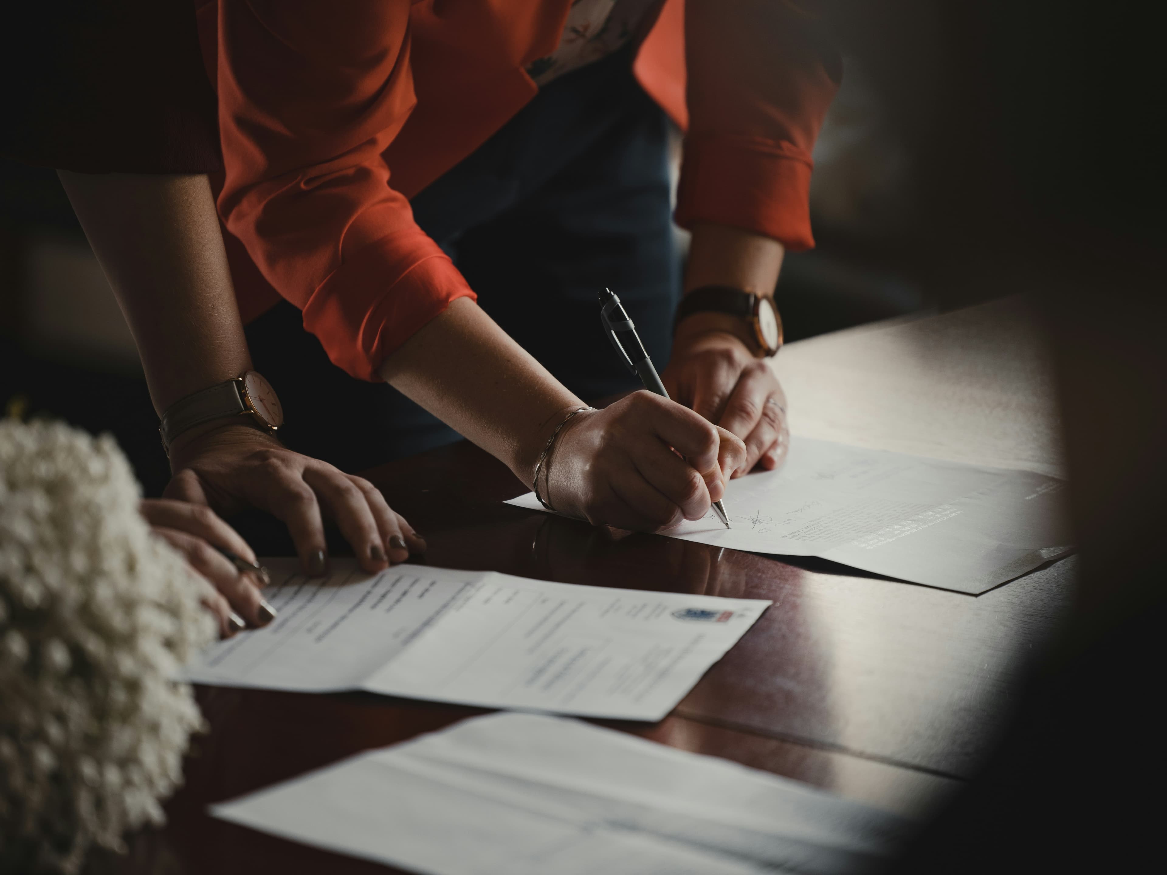 Person signing settlement documents after a car accident