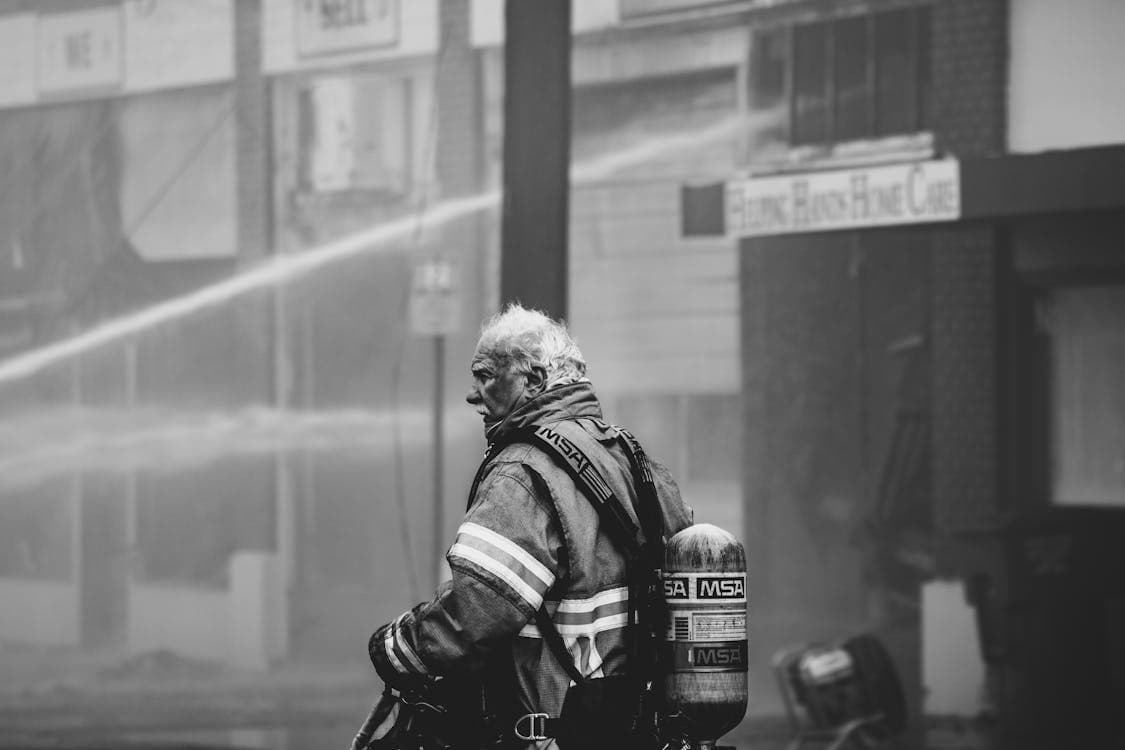 Firefighter in full protective gear at an accident scene, representing the first responder expertise behind Accident Support